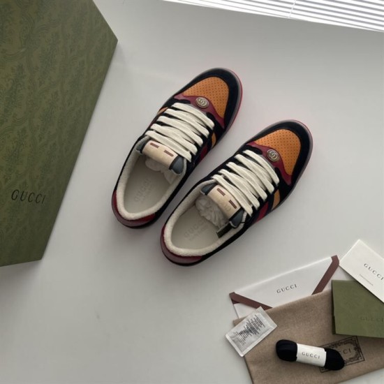 Gucci Screener Trainers In Black Suede And Orange Pair Overview Pair of Gucci Screener trainers in black suede and orange shown with branded accessories.