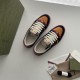 Gucci Screener Trainers In Black Suede And Orange Pair Overview Pair of Gucci Screener trainers in black suede and orange shown with branded accessories.