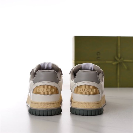 Gucci Off White Leather Trainer Heel View in off-white and grey Rear view of Gucci off-white trainers showing embossed logo heel patches and grey collars