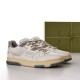 Gucci Off White Panelled Trainers Front Three-Quarter View in off-white and grey Angled pair view of Gucci off-white panelled trainers with grey details and branded green box