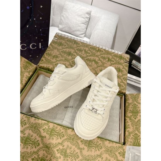 Gucci white low-top trainers placed inside luxury shoe box