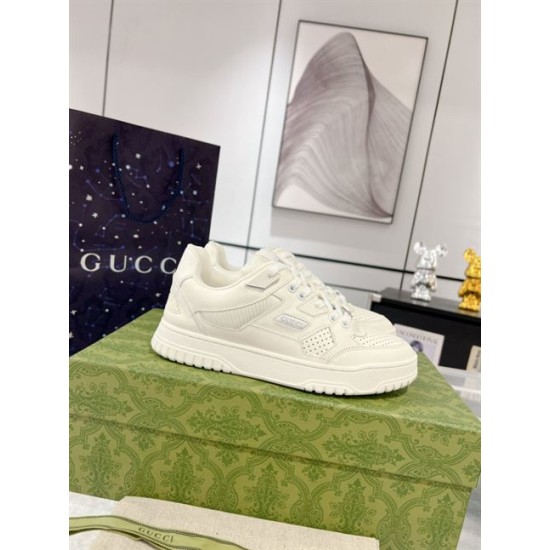 Side view of Gucci white low-top leather trainer on box