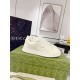 Side view of Gucci white low-top leather trainer on box
