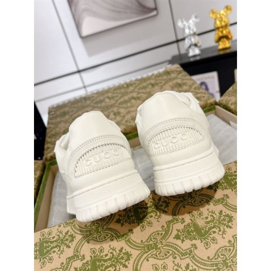 Rear view showing embossed heel logo on Gucci white trainers