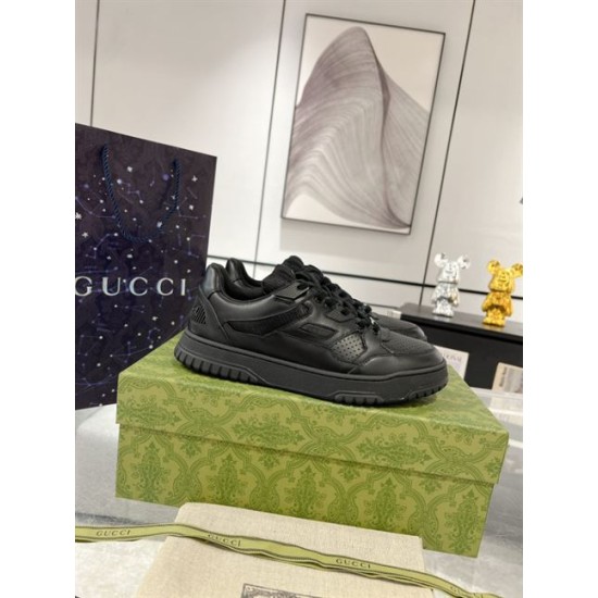 Gucci black trainer displayed on a branded box