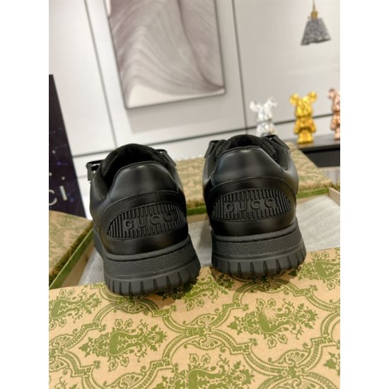 Rear view of both Gucci trainers showing embossed heel logos in black