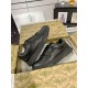 Pair of black Gucci low top leather trainers resting inside box