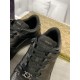 Close-up of black laces, tongue tab and metal hardware on Gucci trainer