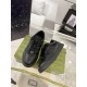 Pair of Gucci low top black leather trainers set on green box