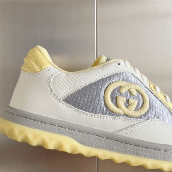 Close-up of side panel detailing on Gucci Mac80 trainers featuring the Interlocking G patch in white and grey