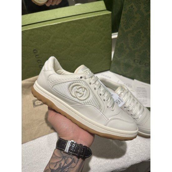 Gucci Mac80 Trainer Held in Hand Lateral View in off-white Hand holding Gucci Mac80 off-white leather trainer showing lateral side