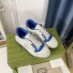 Pair of Gucci Mac80 Off White and Blue Trainers Top Angle Angled top view of a pair of off-white and blue Gucci trainers resting on a green shoebox in off white and blue
