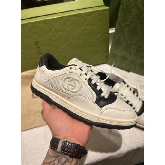 Gucci Mac80 Low Top Trainer Handheld Profile in off white and black Gucci Mac80 Off White And Black Leather Low Top Trainer held in hand showing lateral profile
