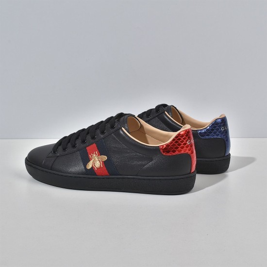 Gucci Men's Ace Bee Embroidered Black Leather Trainers - Heel Detail View Rear side view of Gucci Men's Ace Bee Embroidered Black Leather Trainers highlighting red and blue metallic heel tabs
