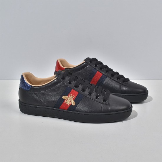 Gucci Men's Ace Bee Embroidered Black Leather Trainers - Three-Quarter Angle Angled front view of Gucci Men's Ace Bee Embroidered Black Leather Trainers displaying the gold bee embroidery