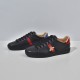 Gucci Men's Ace Bee Embroidered Black Leather Trainers - Perspective View Side profile of Gucci Men's Ace Bee Embroidered Black Leather Trainers on a plain white surface