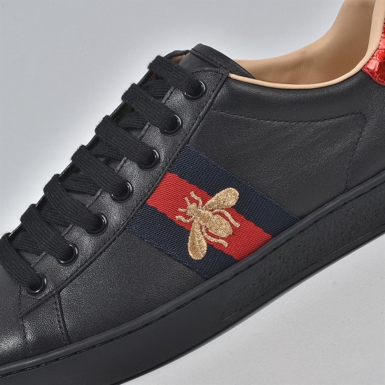 Gucci Men's Ace Bee Embroidered Black Leather Trainer - Bee Embroidery Close-Up Close-up of the gold bee embroidery and web stripe on the Gucci Men's Ace Bee Embroidered Black Leather Trainer