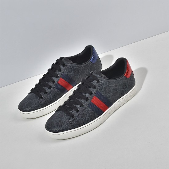 Angled front view of pair of Gucci Ace GG Supreme black trainers