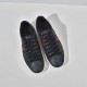Top-down view of Gucci Ace GG Supreme trainers in black showcasing lace-up closure