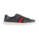 Side profile view of Gucci Ace GG Supreme low-top trainer in black with web stripe