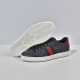 Gucci Ace GG Supreme trainer displayed alongside textured white rubber sole in black
