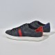 Rear view showing red and blue metallic snake-effect heel tabs on black trainers
