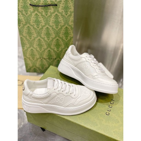 Gucci White Leather Trainers Box Display Pair of Gucci white embossed leather platform trainers resting on green packaging box