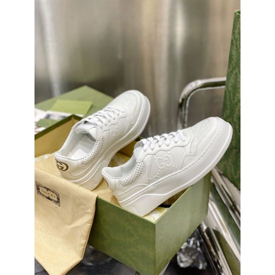 Gucci White Platform Trainers Angle View Side angled view of both Gucci white leather trainers displayed with shoe box