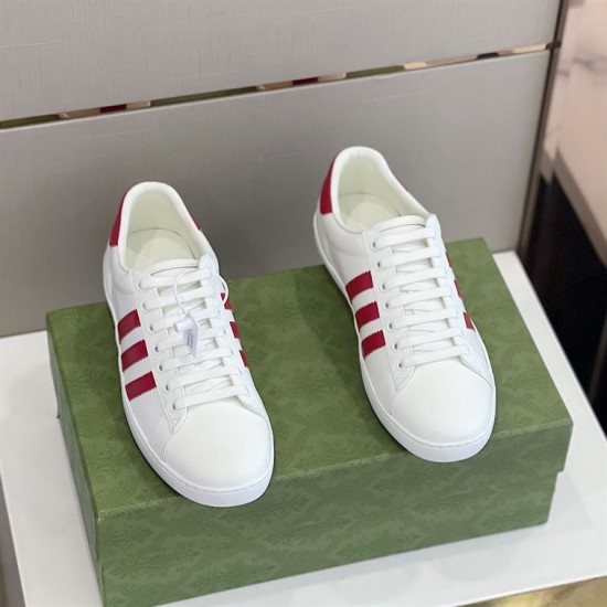 Gucci White and Red Leather Trainers Pair Pair of Gucci white leather trainers with red accents displayed on a green box.