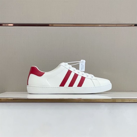 Gucci White and Red Trainer Profile Side view of Gucci white leather trainer featuring red side stripes on display shelf.