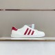 Gucci White and Red Trainer Profile Side view of Gucci white leather trainer featuring red side stripes on display shelf.