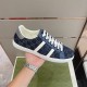 Gucci Men's GG Blue Denim Trainer Handheld Profile Side profile shot of a single Gucci Men's GG Blue Denim Low-Top Trainer held up