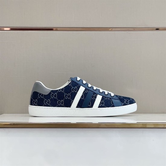 Gucci Men's GG Blue Denim Trainer Lateral View Side view of Gucci Men's GG Blue Denim Low-Top Trainer displayed on a store shelf