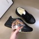 Gucci Rhyton Tiger Print Leather Trainer Printed Detail View in black Hand holding Gucci Rhyton black trainer showing printed tiger face
