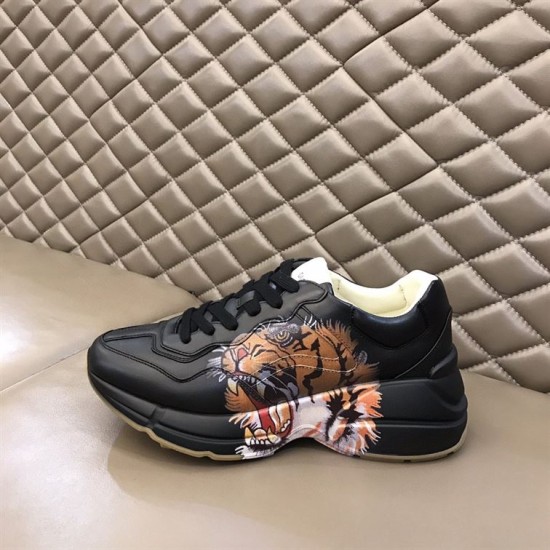 Gucci Rhyton Tiger Print Leather Trainer Profile View in black Side profile of Gucci Rhyton black leather trainer on padded background