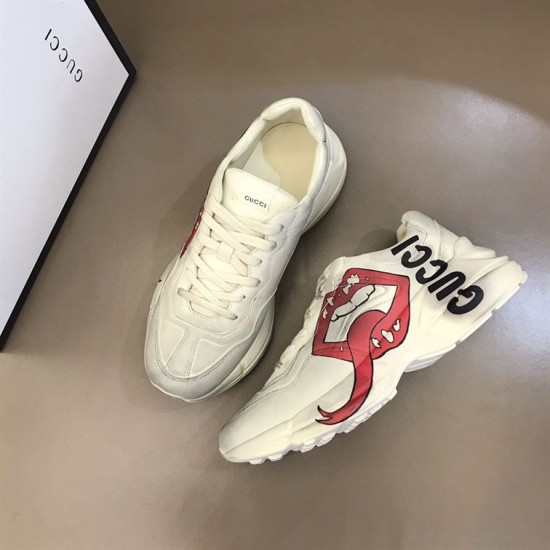 Gucci Mouth Print Trainers Angled Pair View in off white Pair of off white Gucci trainers displayed from above at an angle