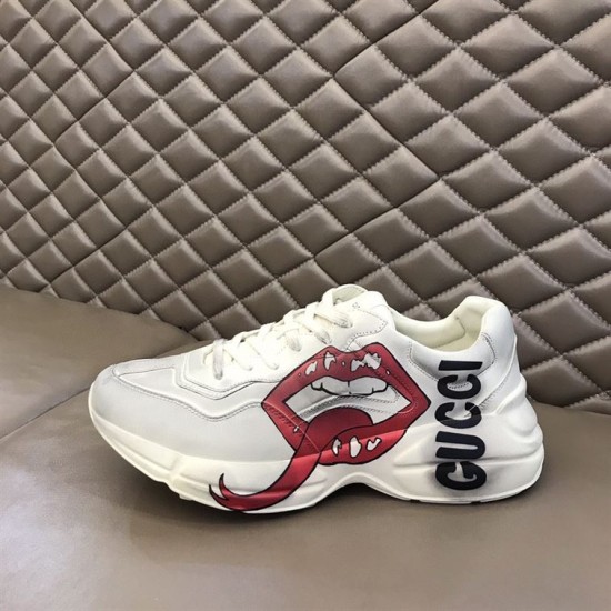 Gucci Rhyton Mouth Graphic Profile in off white Side profile of off white Gucci trainer showing red lips and black lettering