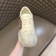 Gucci Rhyton Mouth Print Front Angle in off white Front view of off white Gucci trainer held in hand
