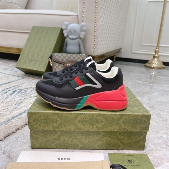 Gucci Rhyton Black Red Trainers Pair View Pair of Gucci Rhyton black red low top trainers resting on a green branded shoebox