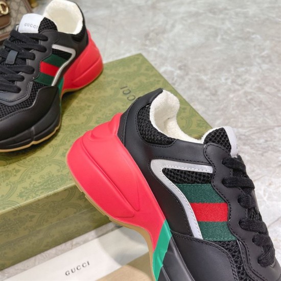 Gucci Rhyton Trainer Midsole and Stripe Detail in black and red Detailed view of side webbing stripe and red chunky heel midsole on Gucci Rhyton trainer in black and red