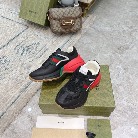 Gucci Rhyton Trainers Top Down Angle in black and red Top-down view of Gucci Rhyton trainers displaying black mesh vamps and white tongue labels in black and red