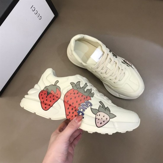 Gucci Rhyton Trainers Display View in ivory and red Pair of Gucci Rhyton trainers in ivory positioned next to shoe box in ivory and red