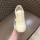 Gucci Rhyton Trainer Front Perspective View in ivory and red Front upper perspective view of Gucci Rhyton ivory trainer showing tongue logo in ivory and red