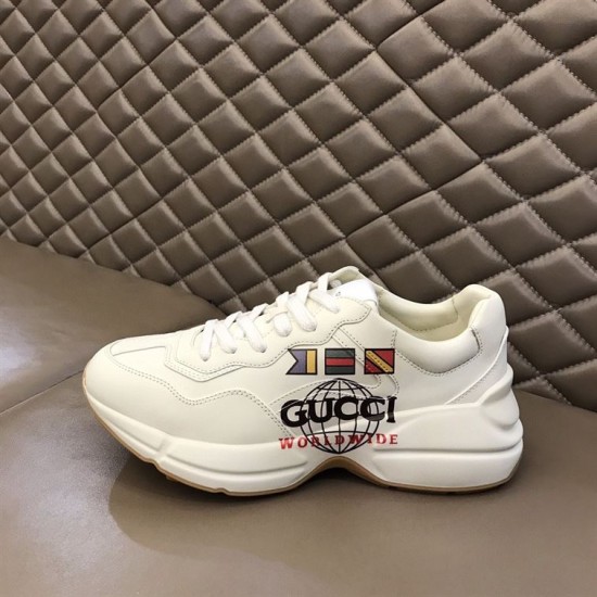 Lateral View of Gucci Rhyton Trainer on Bench in white Lateral profile view of Gucci Rhyton Trainer resting on bench in white