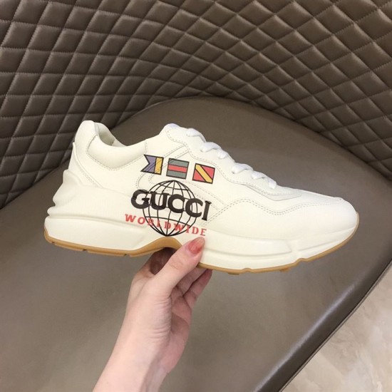 Gucci Rhyton Trainer Side View Held in Hand in white Side view held in hand showing Worldwide print on Gucci Rhyton Trainer in white