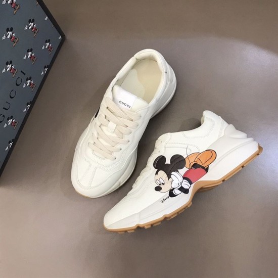 Gucci x Disney Rhyton Trainers High-Angle Pair in ivory High-angle view of both Gucci x Disney Rhyton trainers displaying side details in ivory