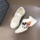 Gucci x Disney Rhyton Trainers High-Angle Pair in ivory High-angle view of both Gucci x Disney Rhyton trainers displaying side details in ivory