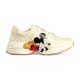 Gucci x Disney Rhyton Ivory Trainer Lateral View Side view of Gucci x Disney Rhyton ivory leather trainer with graphic print