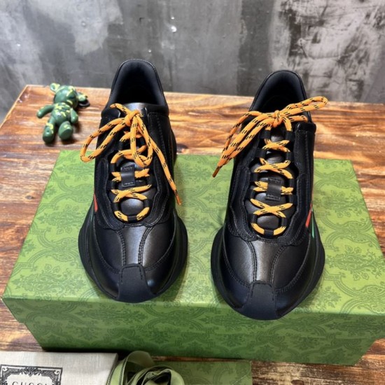 Gucci Black Leather Trainers Front Angle Front view of Gucci Black Leather Interlocking G Side-Stripe Trainers showing orange laces