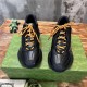Gucci Black Leather Trainers Front Angle Front view of Gucci Black Leather Interlocking G Side-Stripe Trainers showing orange laces